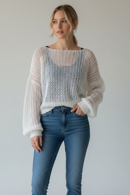 Stassia 12 white mohair knit sweater with a loose weave and balloon sleeves, paired with black pinstripe pants.